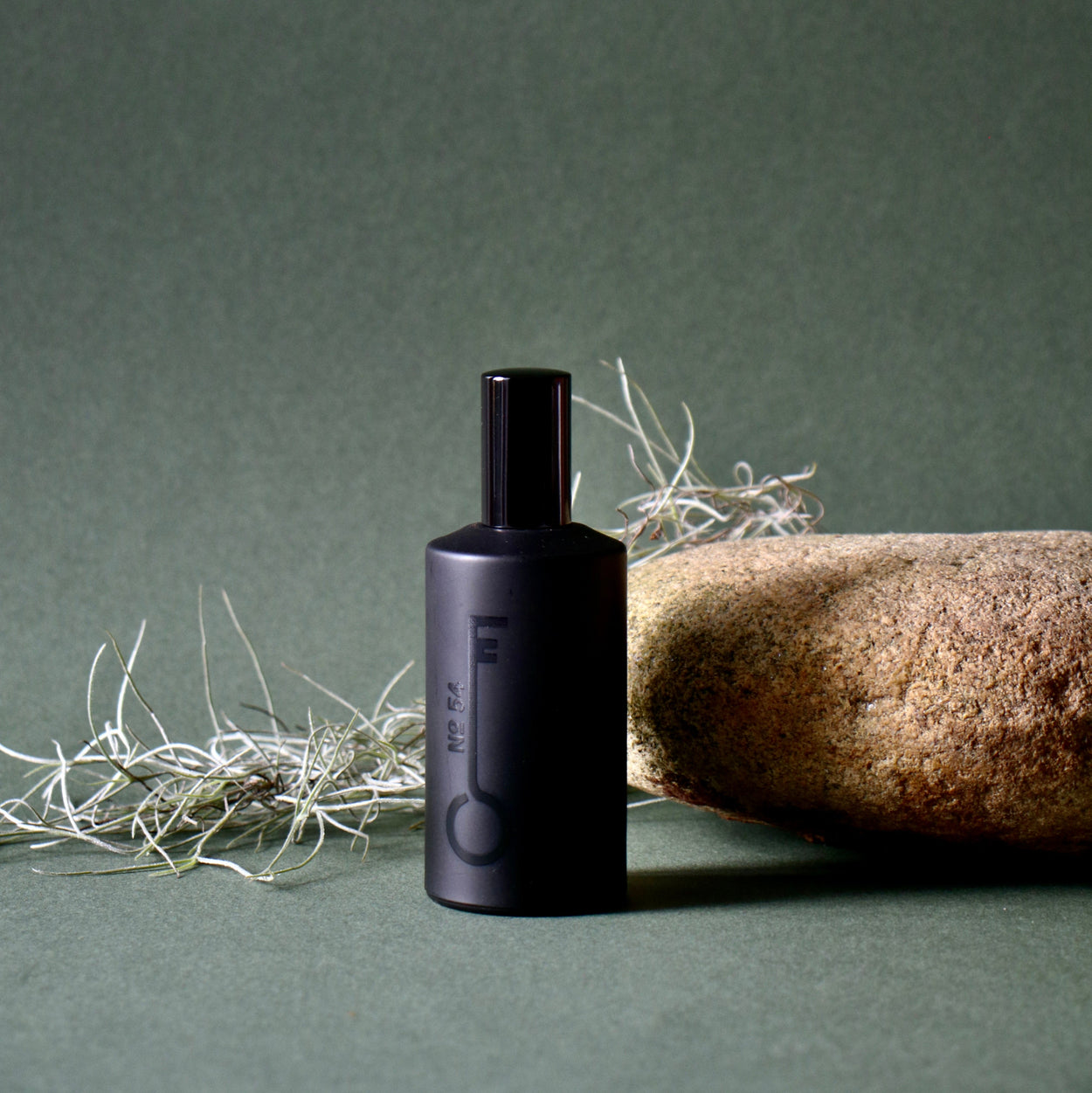 Black bottle with a label on a green background