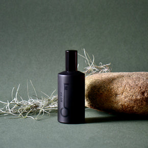 Black bottle with a label on a green background