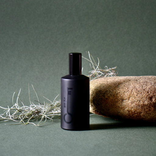 Black bottle with a label on a green background