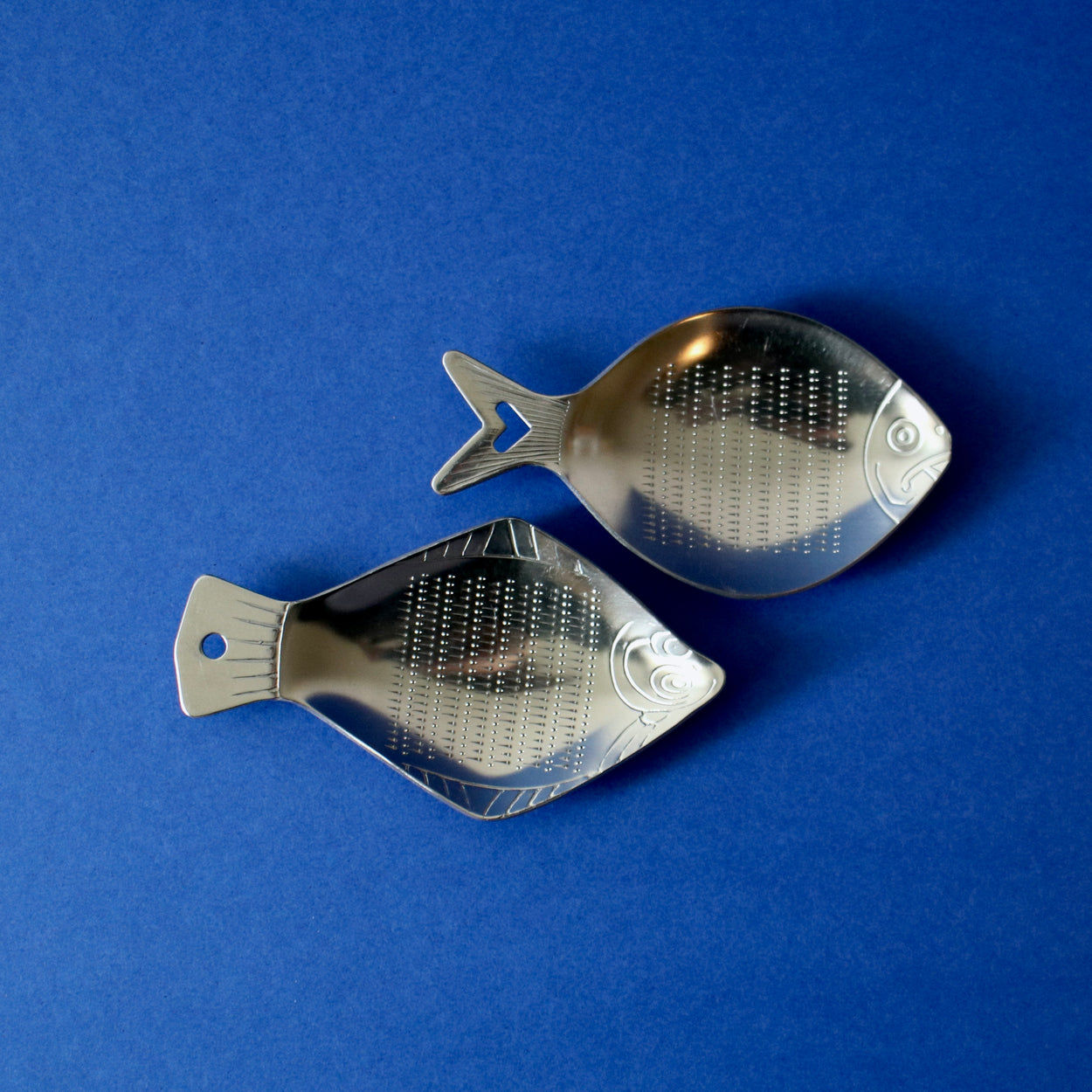 Two Japanese Ginger Grater - Fish with blue background.
