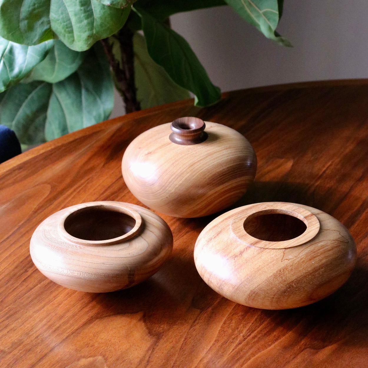 Group of Vintage wood  low vase on wood table.