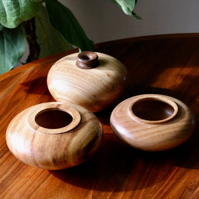 Group of Vintage wood turned vases on wood table.