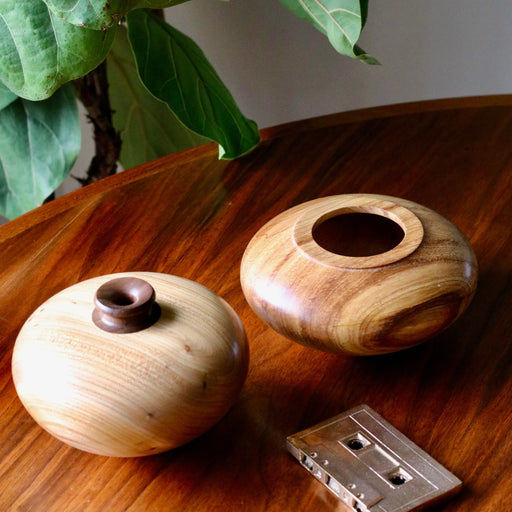 Two Vintage wood turned vase on wood table with bronze cassette tape.