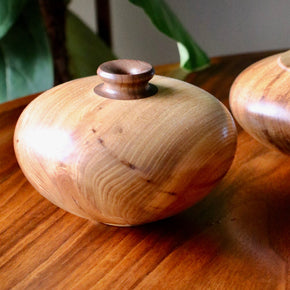 Vintage wood turned vase on wood table, close up.