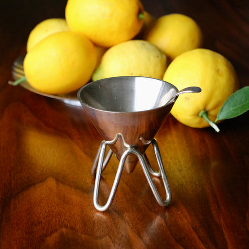 Vintage silver sugar bowl set, on wood table with bowl of lemons.