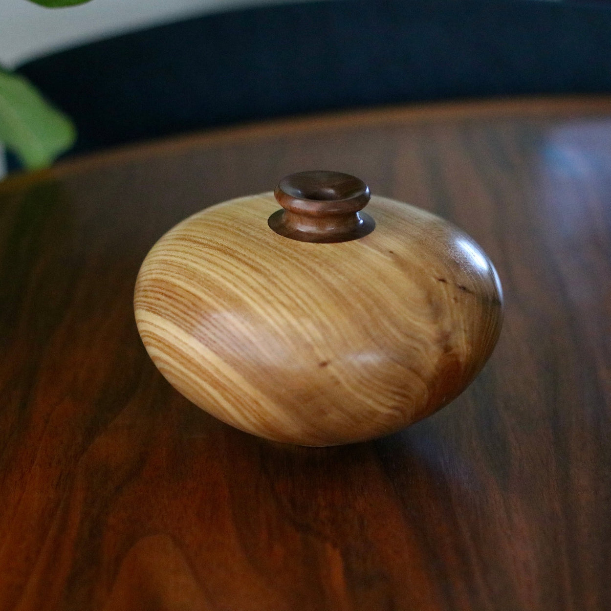 Vintage wood turned vase on wood table.