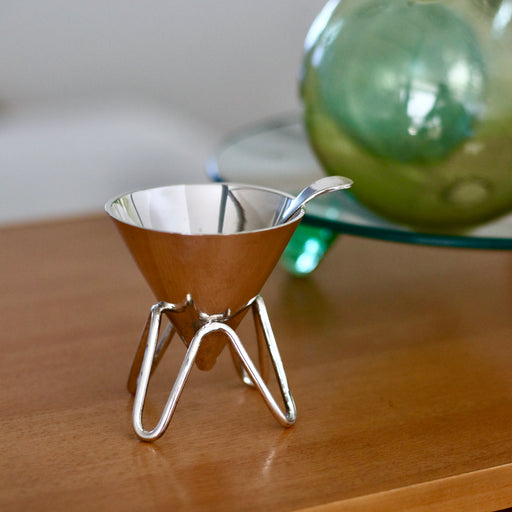 Vintage silver sugar bowl set on bench with 90s glass.