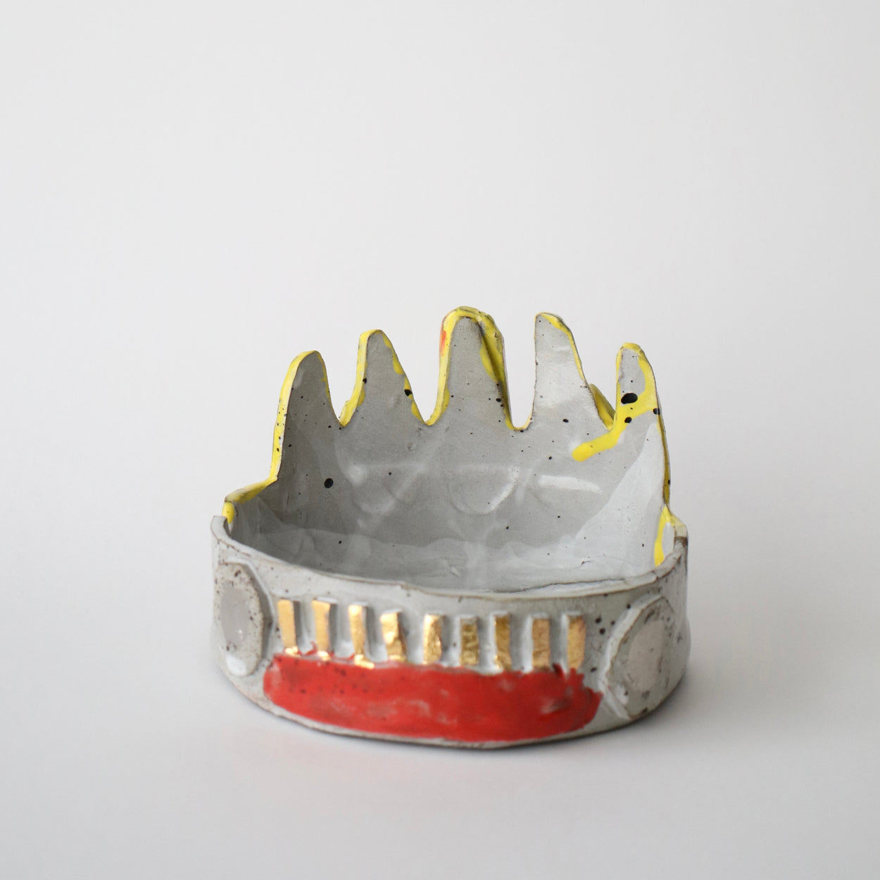 Ceramic bowl with textured surface and red accent on a white background