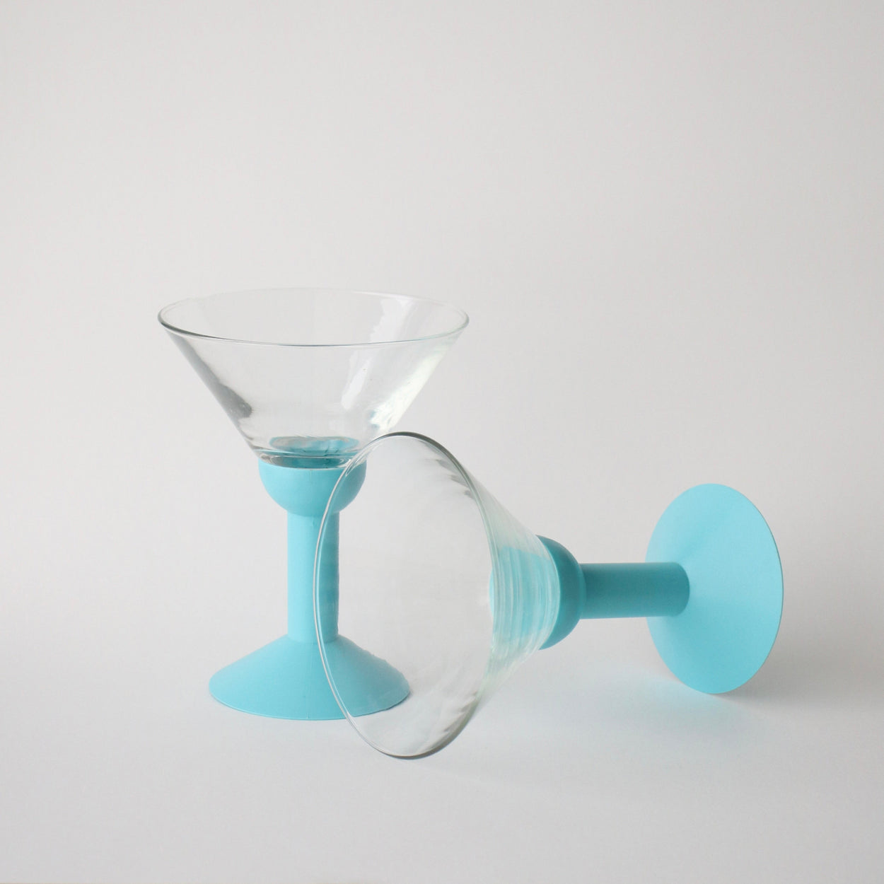 Clear glass with light blue silicone base on a white background