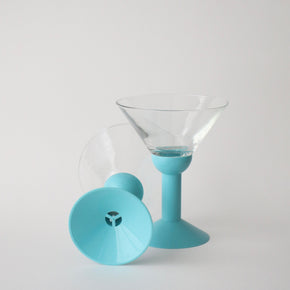 Clear glass with blue silicone base and rim on a light gray background