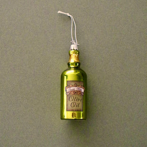 Decorative olive oil bottle ornament on a plain background