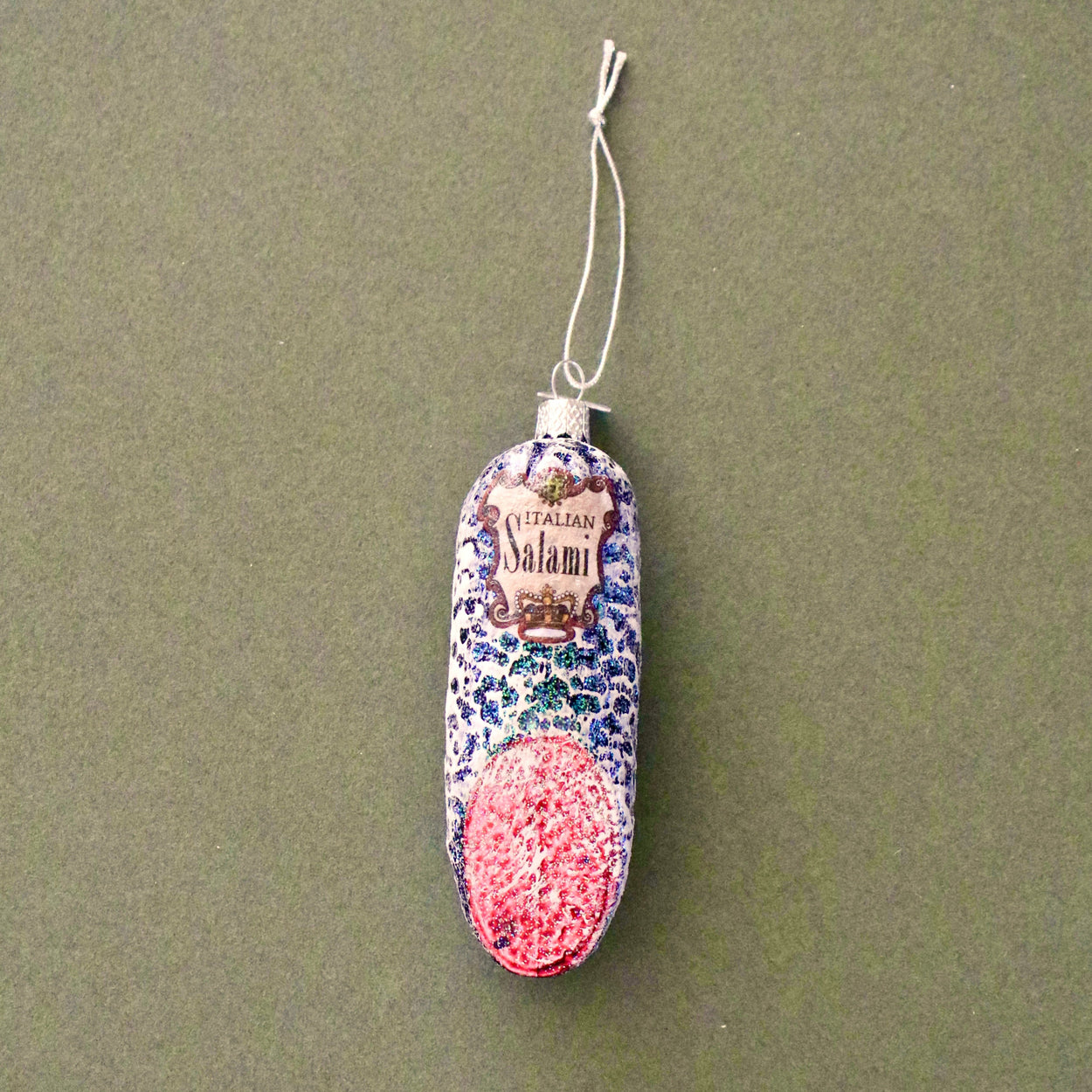 Decorative salami with colorful pattern on a green background