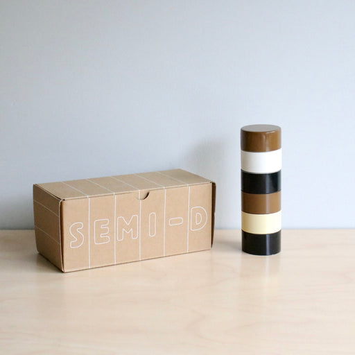 Semi D branded box next to a brown striped pepper Grinder.