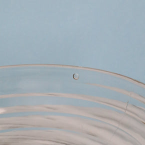 Close-up of a air bubble on glass with a light blue background