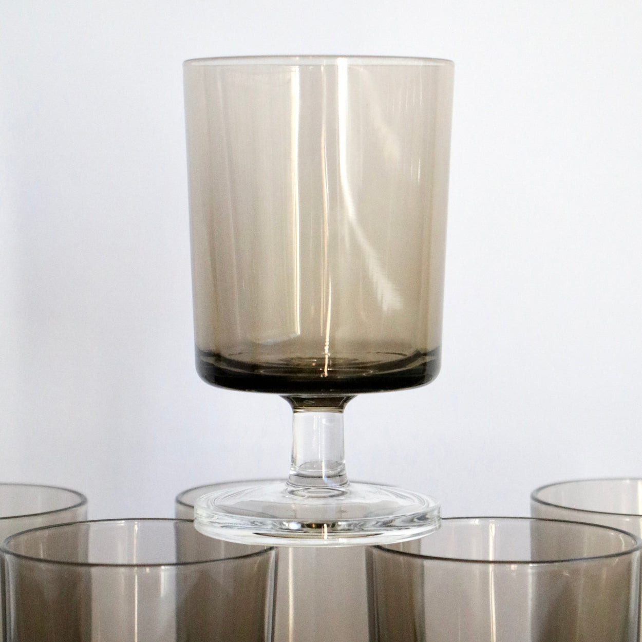 Set of smoked glass tumblers on a white background