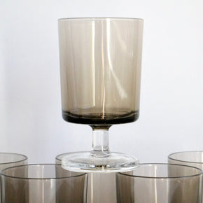 Set of smoked glass tumblers on a white background