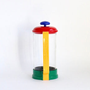 Colourful french press with a yellow handle on a white background