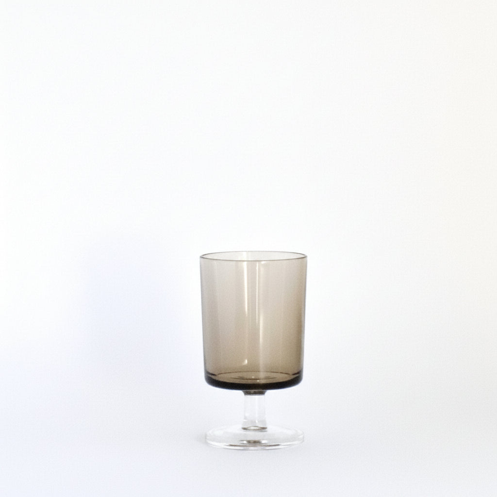 Smoky glass tumbler on a white background