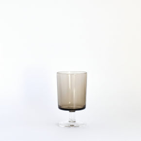Smoky glass tumbler on a white background