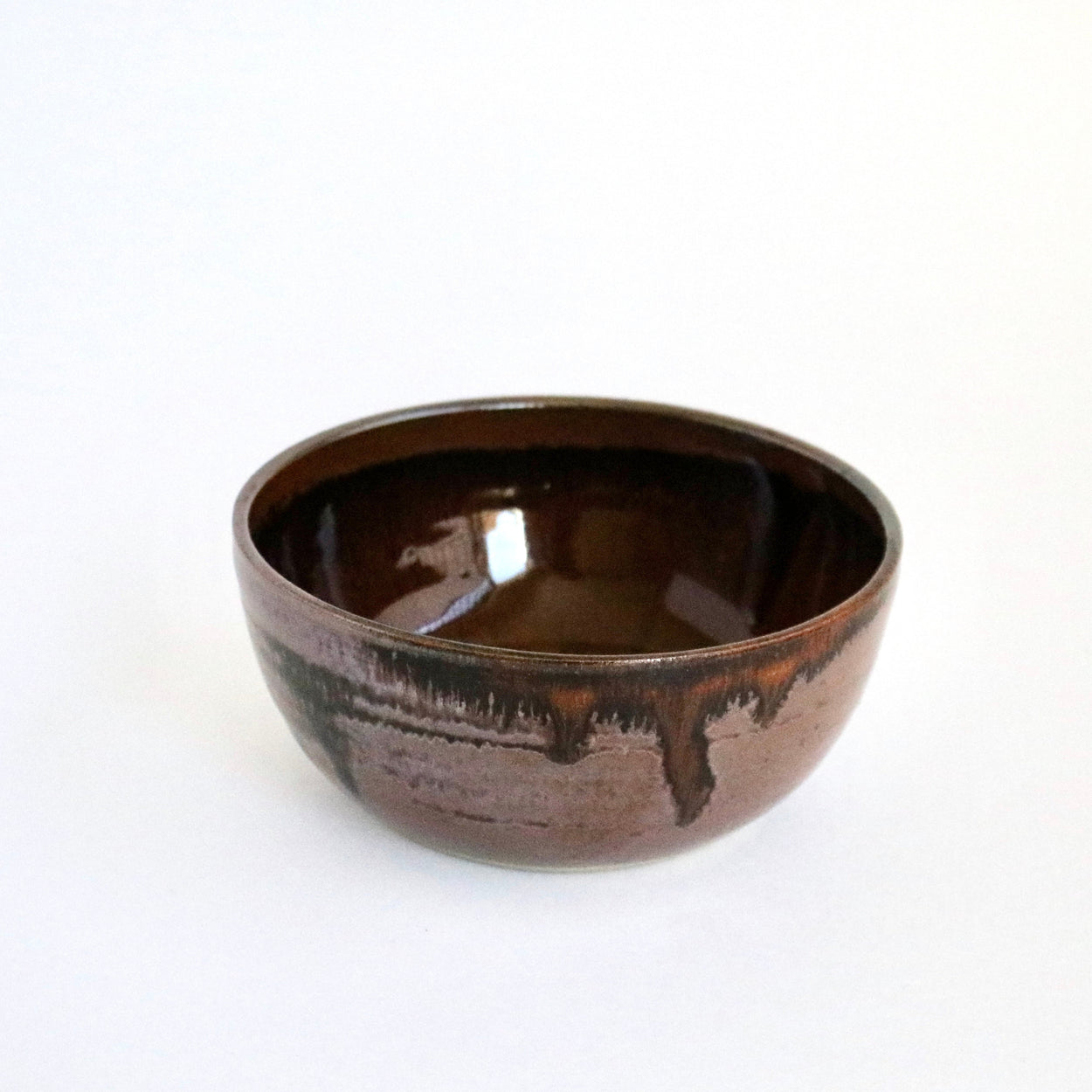 Brown ceramic bowl on a white background