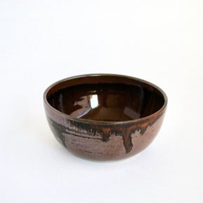 Brown ceramic bowl on a white background