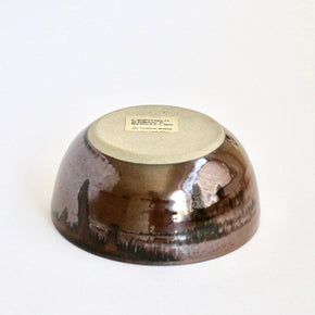 Ceramic bowl with a textured surface on a white background