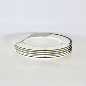 Stack of white ceramic plates on a light gray background
