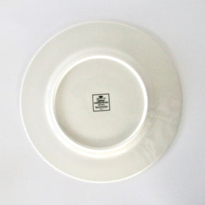 White ceramic plate with a visible brand logo on a white background