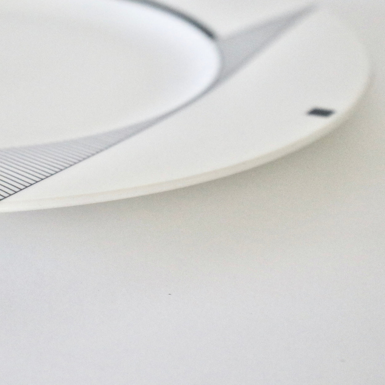 Close-up of a white plate on a light background
