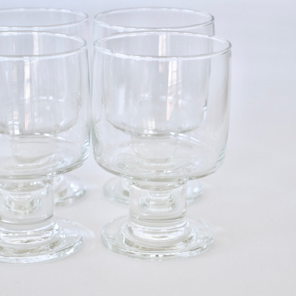 Clear glass goblets on a white background