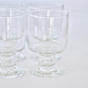 Clear glass goblets on a white background