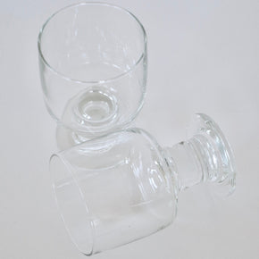 Two clear glass goblets on a white background