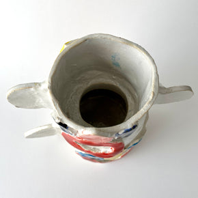 Interior of ceramic vase with colourful design on a white background