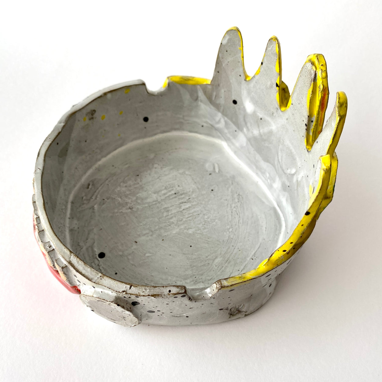 Ceramic bowl with yellow accents on a white background