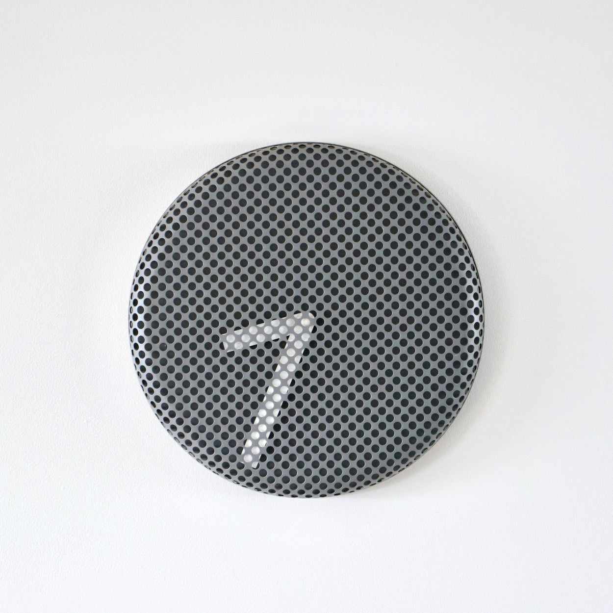 Round metallic clock with a textured surface on a white background