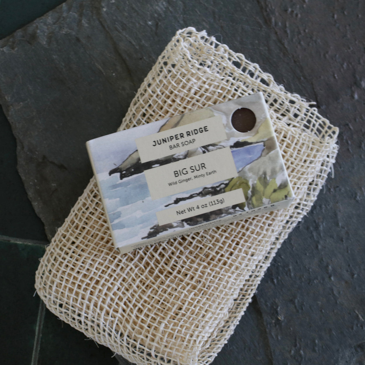 Juniper Ridge Big Sur bar soap on loofa on slate and green tiles