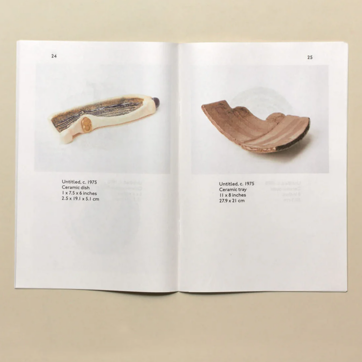 Open book showing images of ceramic artifacts on a beige background
