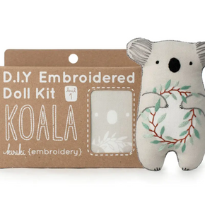 Embroidered doll kit with a koala design on a white background