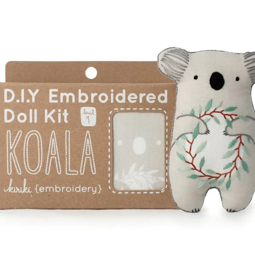 Embroidered doll kit with a koala design on a white background