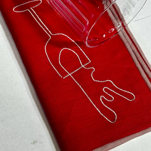 Red napkin with white line art of a glass on a light gray background