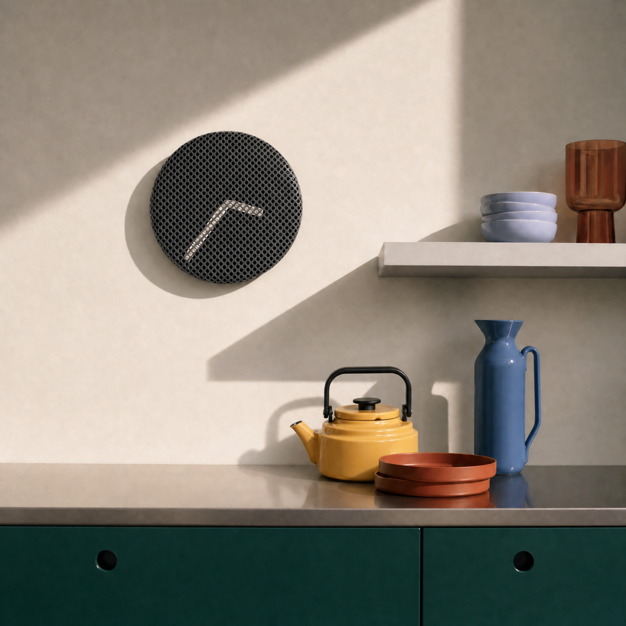 Modern kitchen scene with a wall clock, teapot, and vases on a countertop.