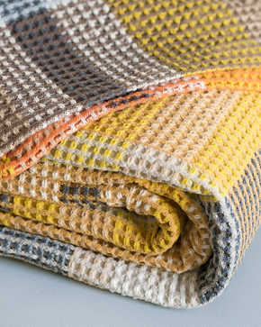 Folded close up of Mungo Vrou-Vrou Cotton Waffle Blanket - Tamarind