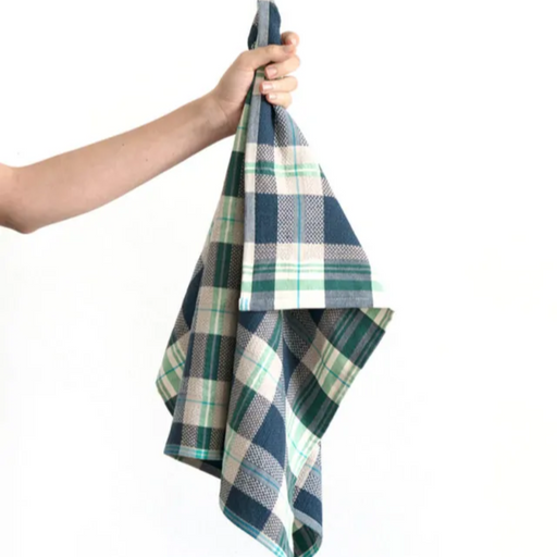 Arm holding Mungo Vadoek Tea Towel in Cobalt.