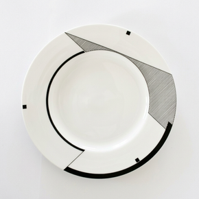 White plate with black geometric design on a white background