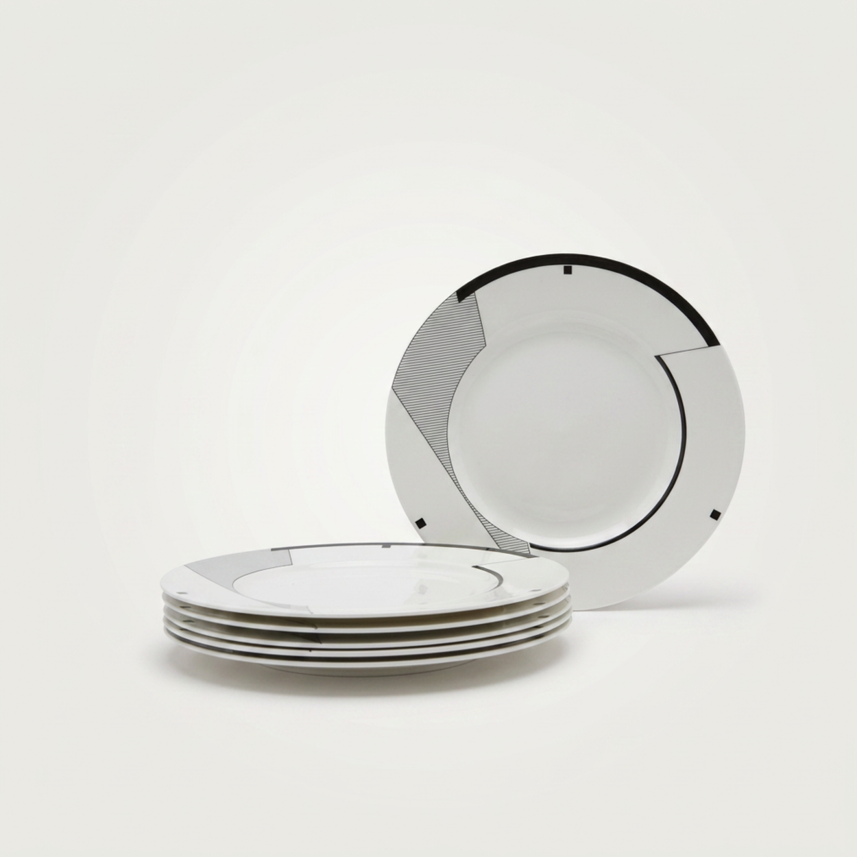 Set of white plates with black rim on a white background