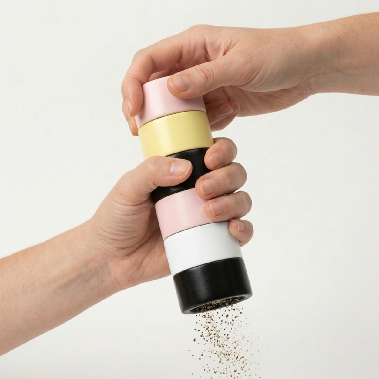Colorful striped Semi D salt grinder being used with a white background