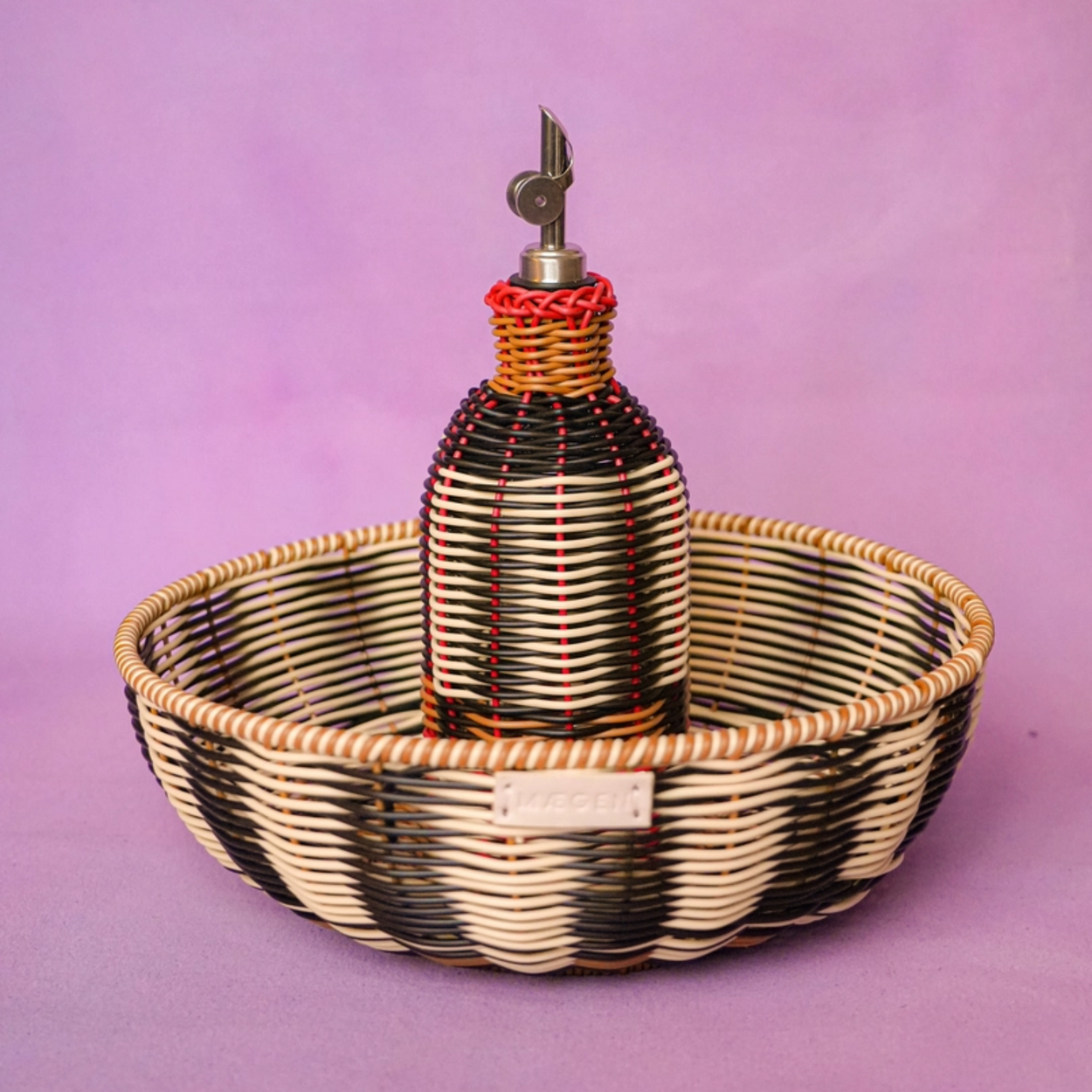 Woven basket with a bottle on a purple background