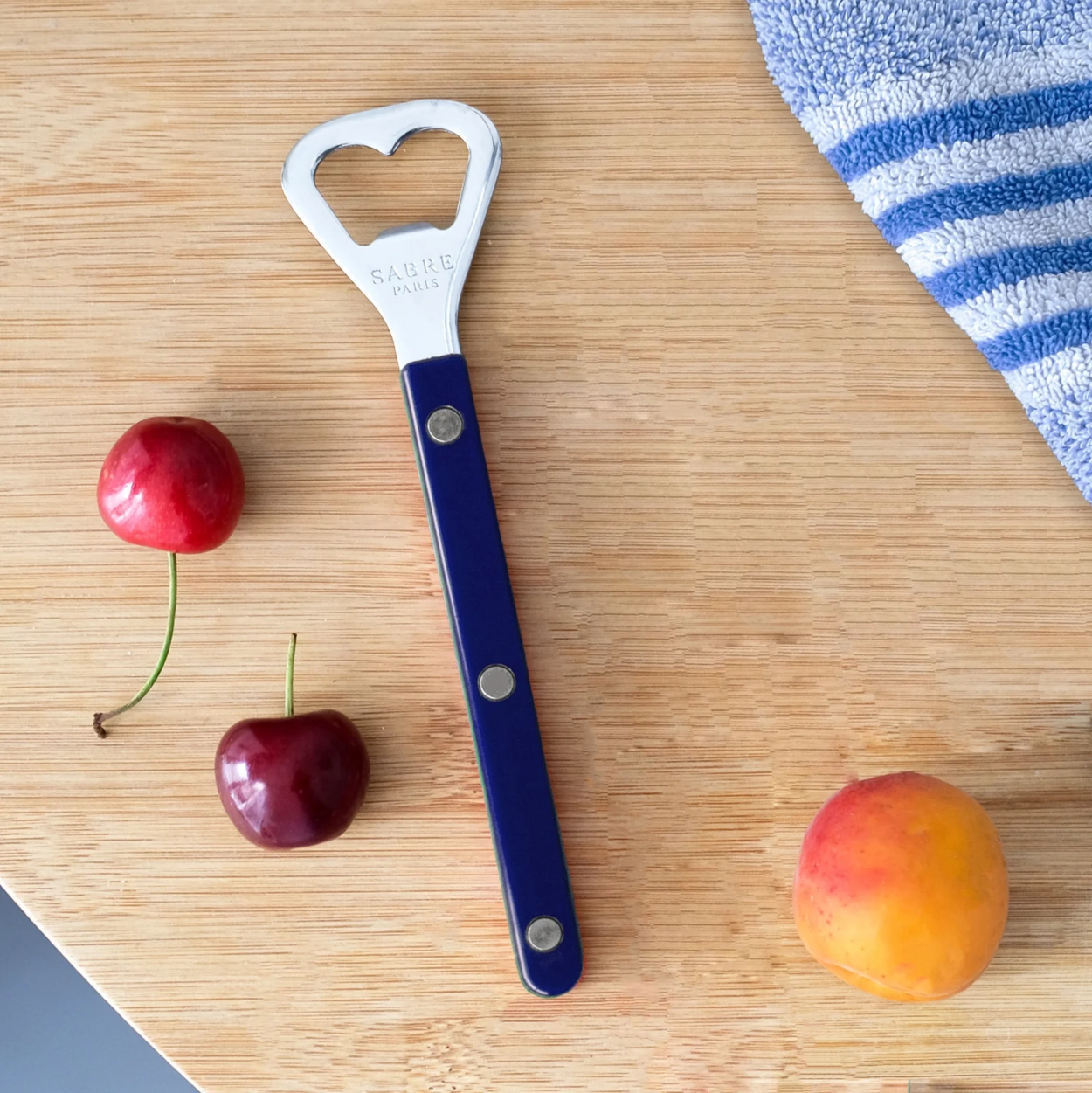 Sabre Paris bottle opener on wooden table