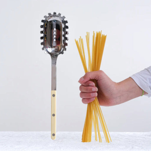 Womens hand holding pasta next to a ivory Sabre Paris Bistrot Spaghetti Server