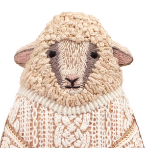 Textured sheep-shaped object with a knitted pattern on a white background